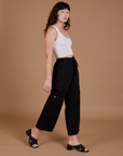 Angled front view of Drop Pocket Cargo Pants in Basic Black and Cropped Tank in vintage tee white on Alex