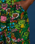 Close up of Kandia's hand in the front pocket of Pond Party Print Jumpsuit