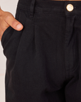 Front close up of Heavyweight Trousers in Basic Black. Jesse has their hand in the pocket.