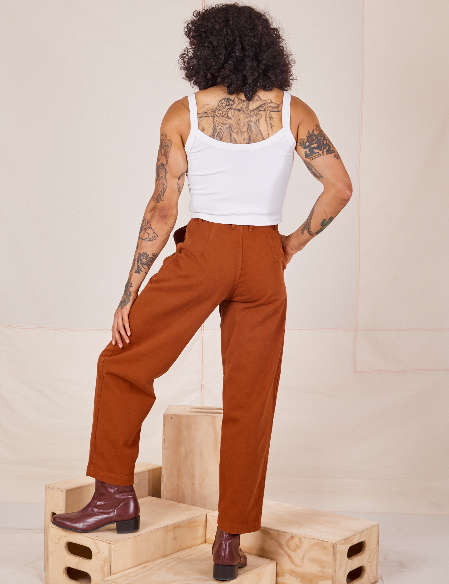 Back view of Heavyweight Trousers in Burnt Terracotta and Cropped Cami in vintage tee off-white worn by Jesse