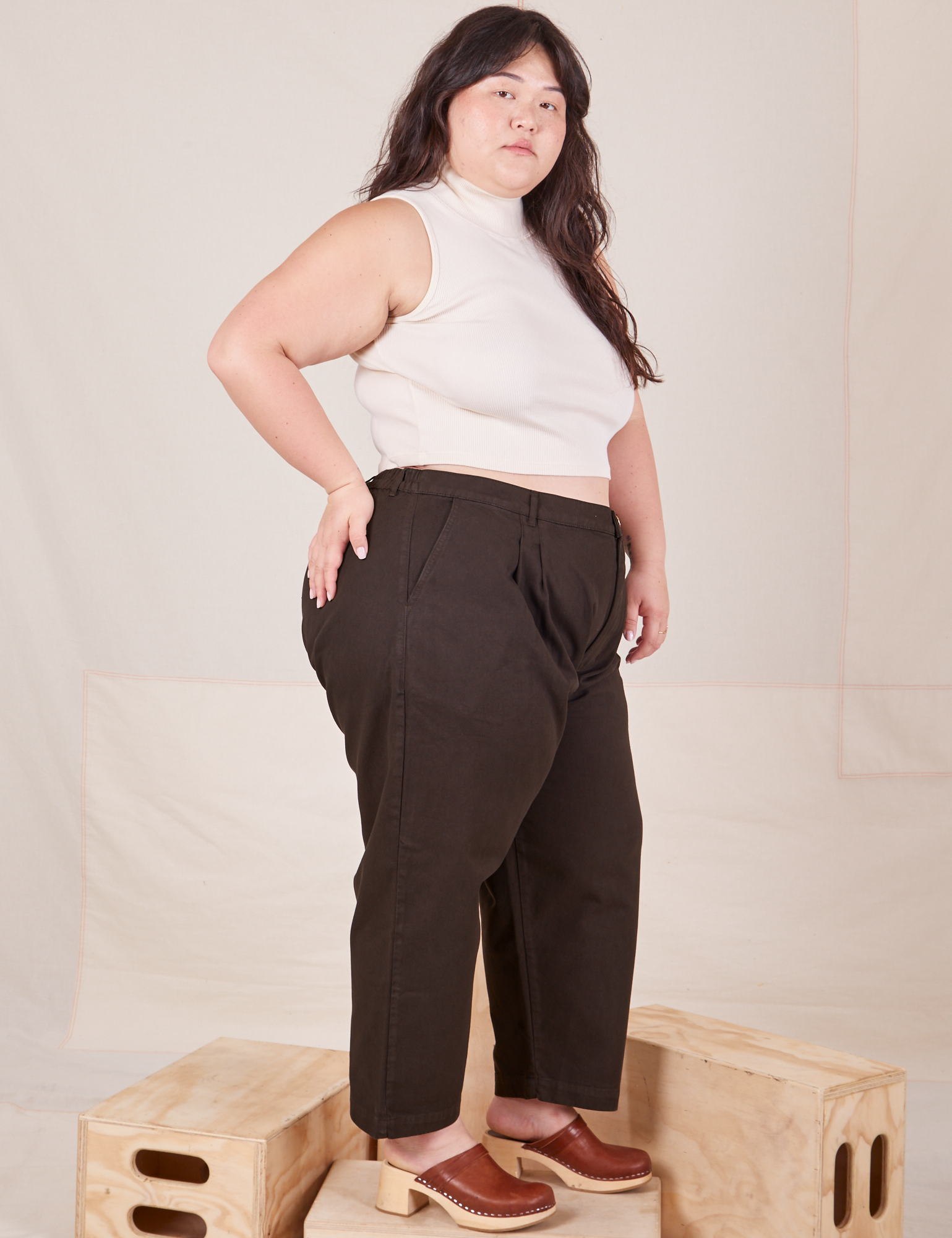 Side view of Heavyweight Trousers in Espresso Brown and Sleeveless Turtleneck in vintage tee off-white worn by Ashley