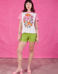 Alex is wearing Anniversary Tee in Pink Poppy and gross green Work Shorts