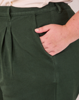 Heritage Trousers in Swamp Green front pocket close up. Juliet has her hand in the pocket.