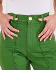 Heritage Westerns in Lawn Green front close up. Soraya has her thumbs in the belt loops