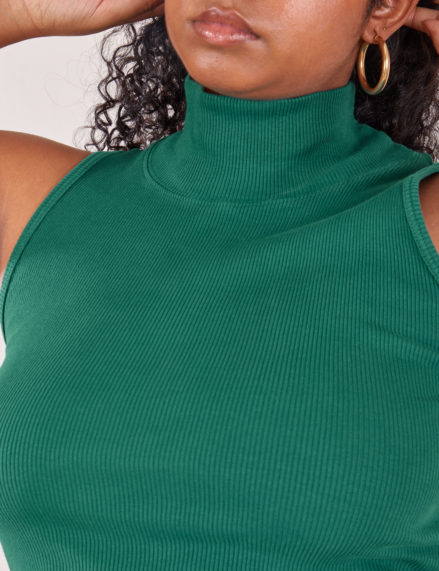 Front close up of Sleeveless Essential Turtleneck in Hunter Green on Meghna