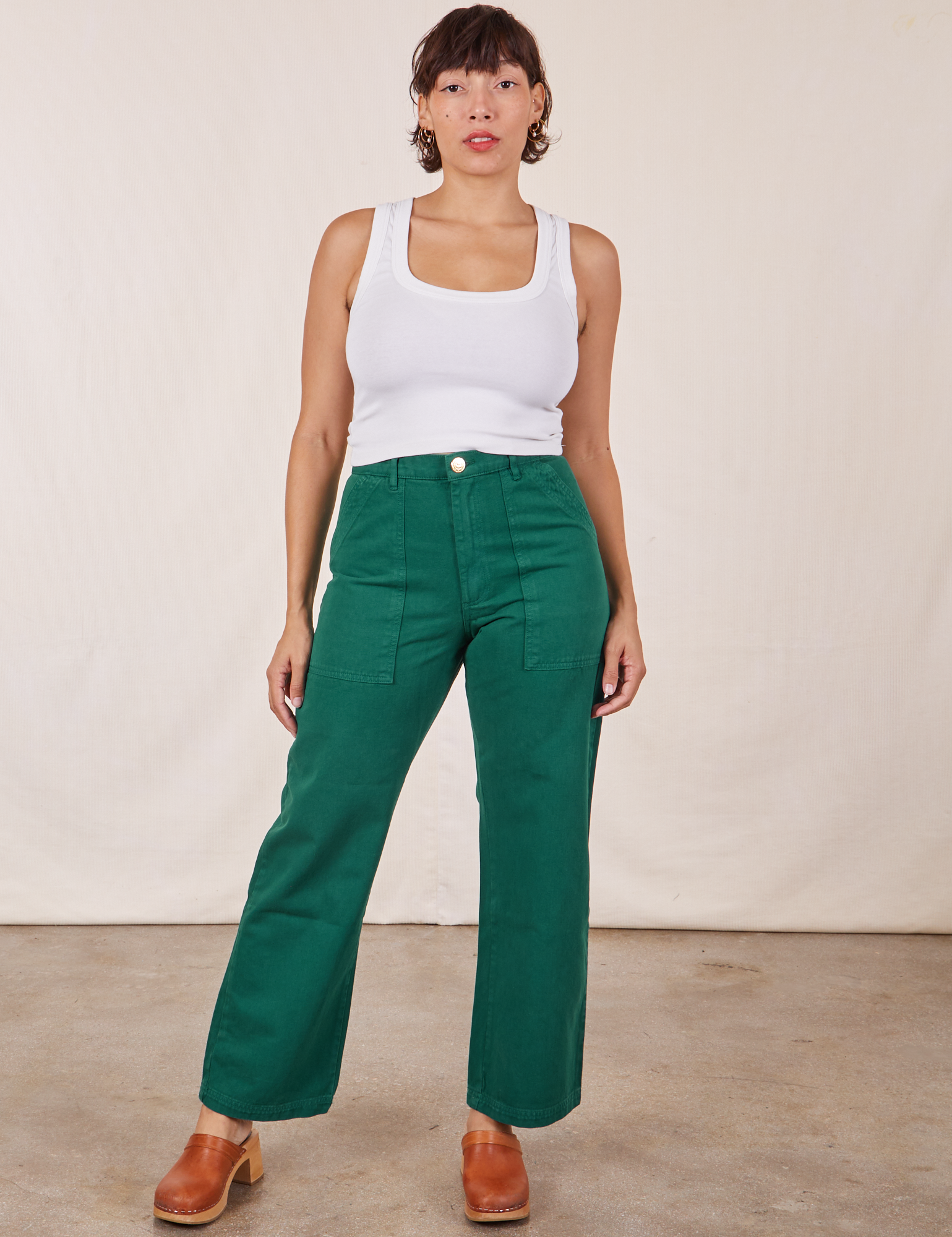 Tiara is wearing Work Pants in Hunter Green and Cropped Tank Top in vintage tee off-white