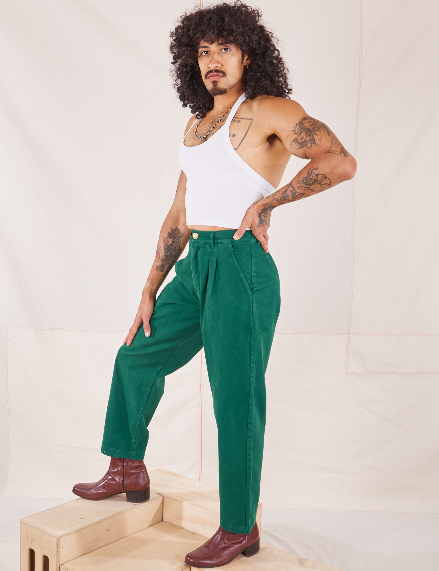 Jesse is wearing Heavyweight Trousers in Hunter Green and Halter Top in vintage tee off-white