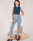 Alex is wearing Muscle Tee in Lagoon and light wash Carpenter Jeans