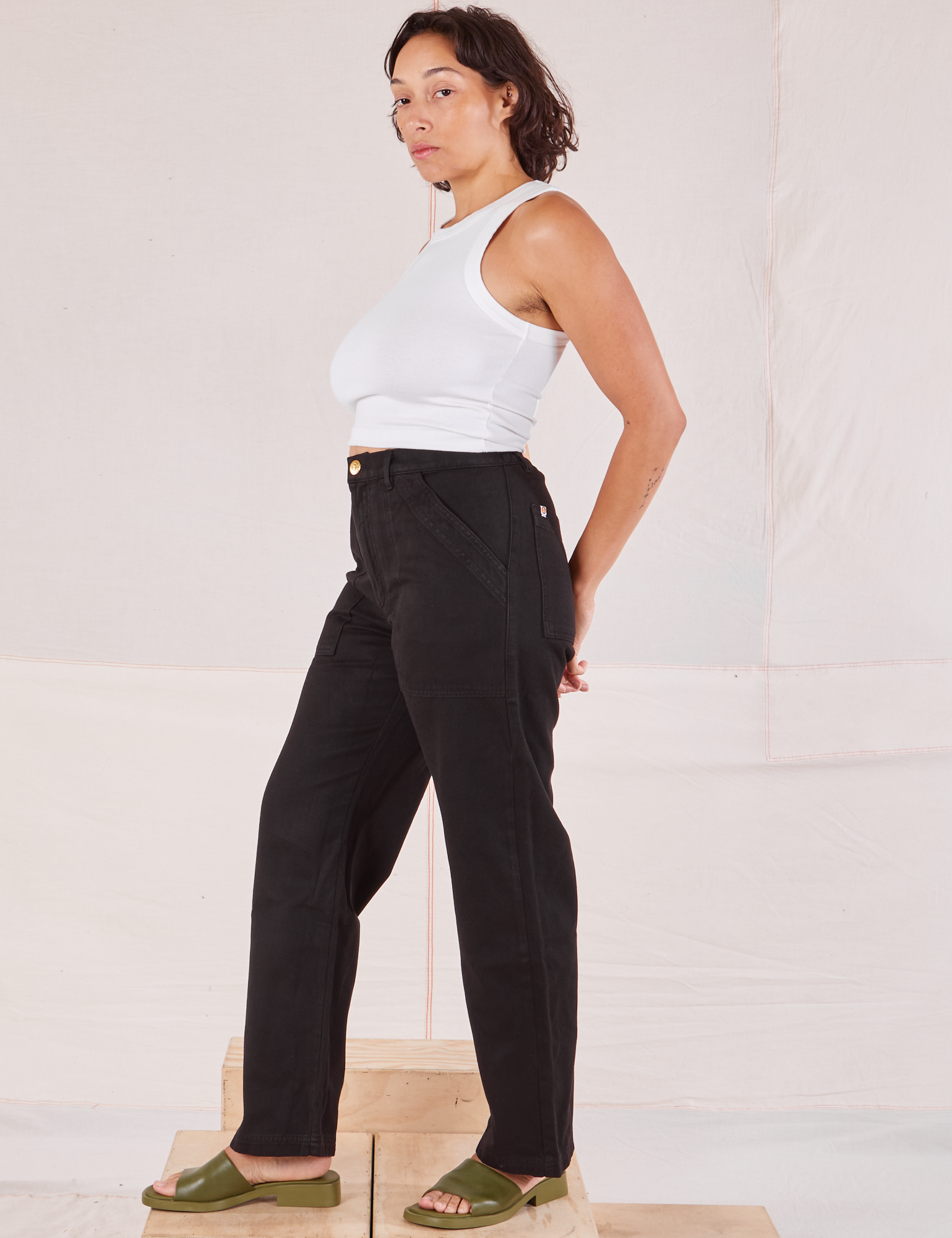 Side view of Organic Work Pants in Basic Black and Racerback Tank in vintage tee off-white on Tiara