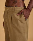 Close up of Jerrod's hand in the front pocket of Baggy Mid-Rise Trousers in Desert Brown