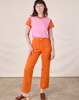 Alex is wearing Mismatched Tee in Pink & Orange and construction orange Work Pants