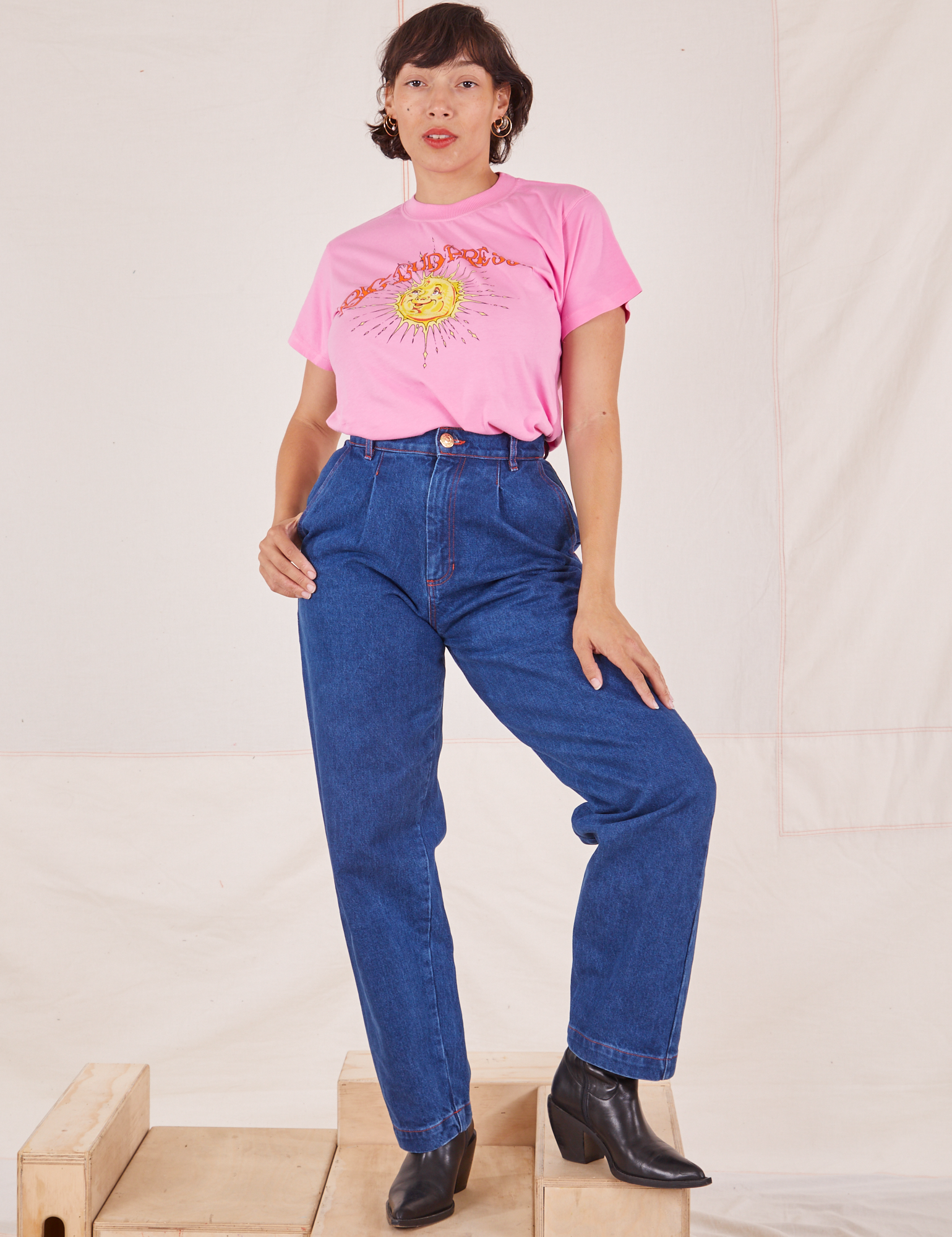 Tiara is wearing Sun Baby Organic Tee in Bubblegum Pink and dark denim Trouser Jeans