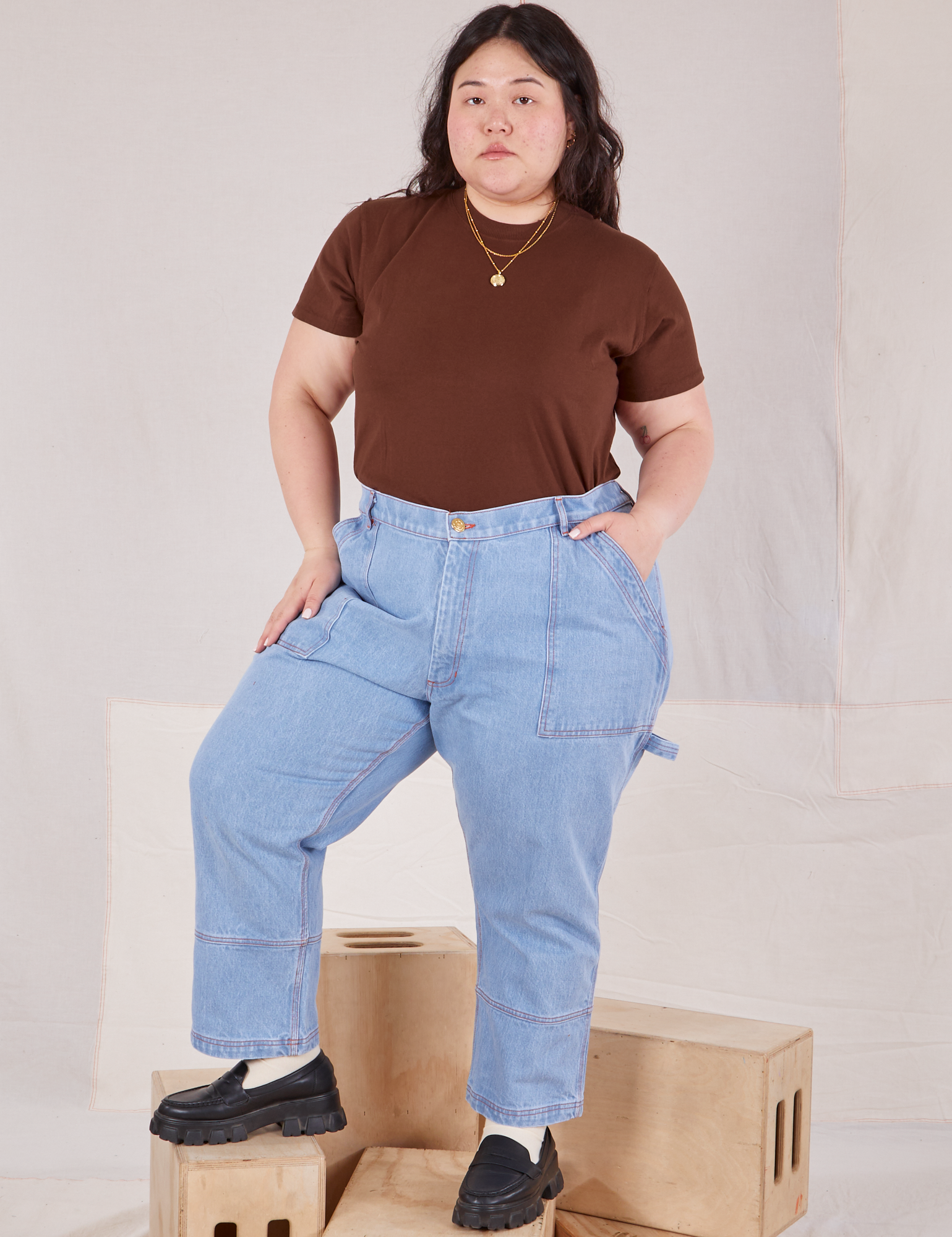 Ashley is wearing Organic Vintage Tee in Fudgesicle Brown tucked into light wash Carpenter Jeans