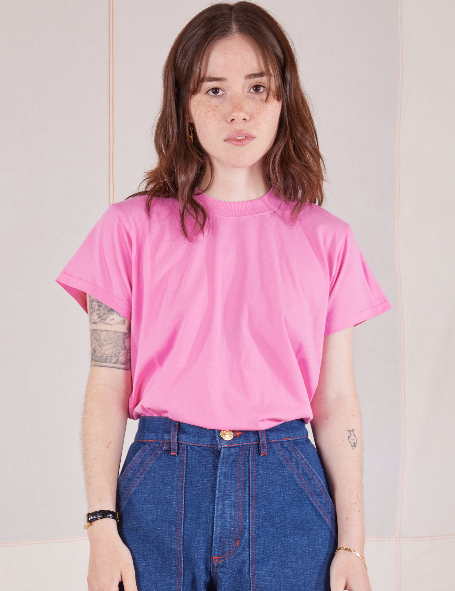Hana is wearing Organic Vintage Tee in Bubblegum Pink tucked into dark wash Carpenter Jeans