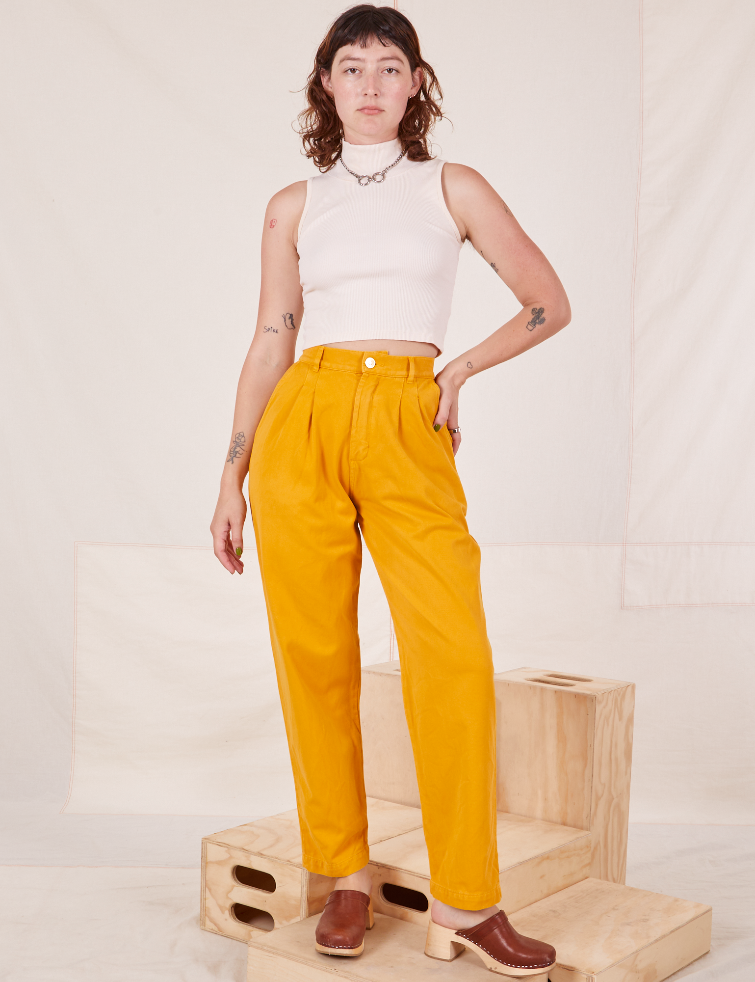 Organic Trousers in Mustard Yellow and Sleeveless Turtleneck in vintage tee off-white worn by Alex
