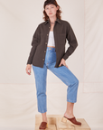 Alex is wearing Oversize Overshirt in Espresso Brown, vintage off-white Cropped Tank Top and light wash Frontier Jeans