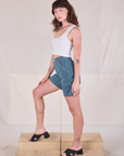 Side view of Railroad Carpenter Shorts in Baby Blue and Cropped Tank in Vintage Tee Off-White
