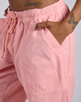 Close up of Kira's hand in the front pocket of Drop Pocket Cargo Pants in Baby Pink