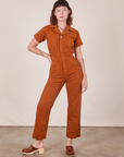 Alex is wearing Short Sleeve Jumpsuit in Burnt Terracotta