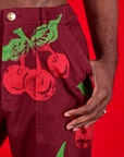 Paintstamped Work Pants in Cherry front pocket close up on Jerrod