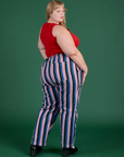 Angled back view of Work Pants in Pacific Stripe and mustang red Cropped Tank on Juliet