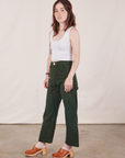 Angled view of Petite Work Pants in Swamp Green and Cropped Tank Top in vintage tee off-white on Hana