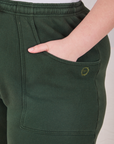 Rolled Cuff Sweat Pants in Swamp Green front pocket close up. Marielena has her hand in the pocket.