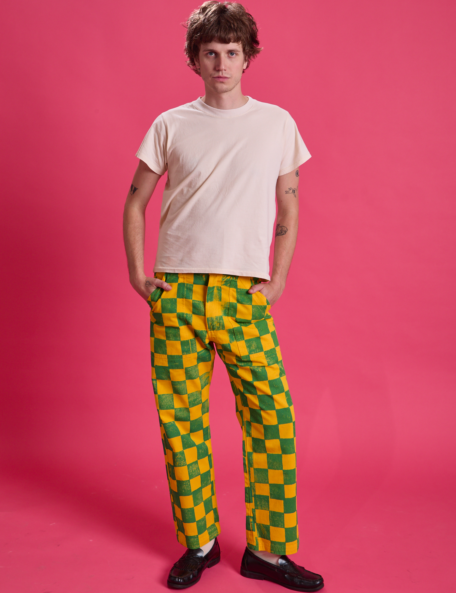 Quinn is wearing Checkerboard Work Pants in Green/Yellow and Organic Vintage Tee in Vintage Off-White