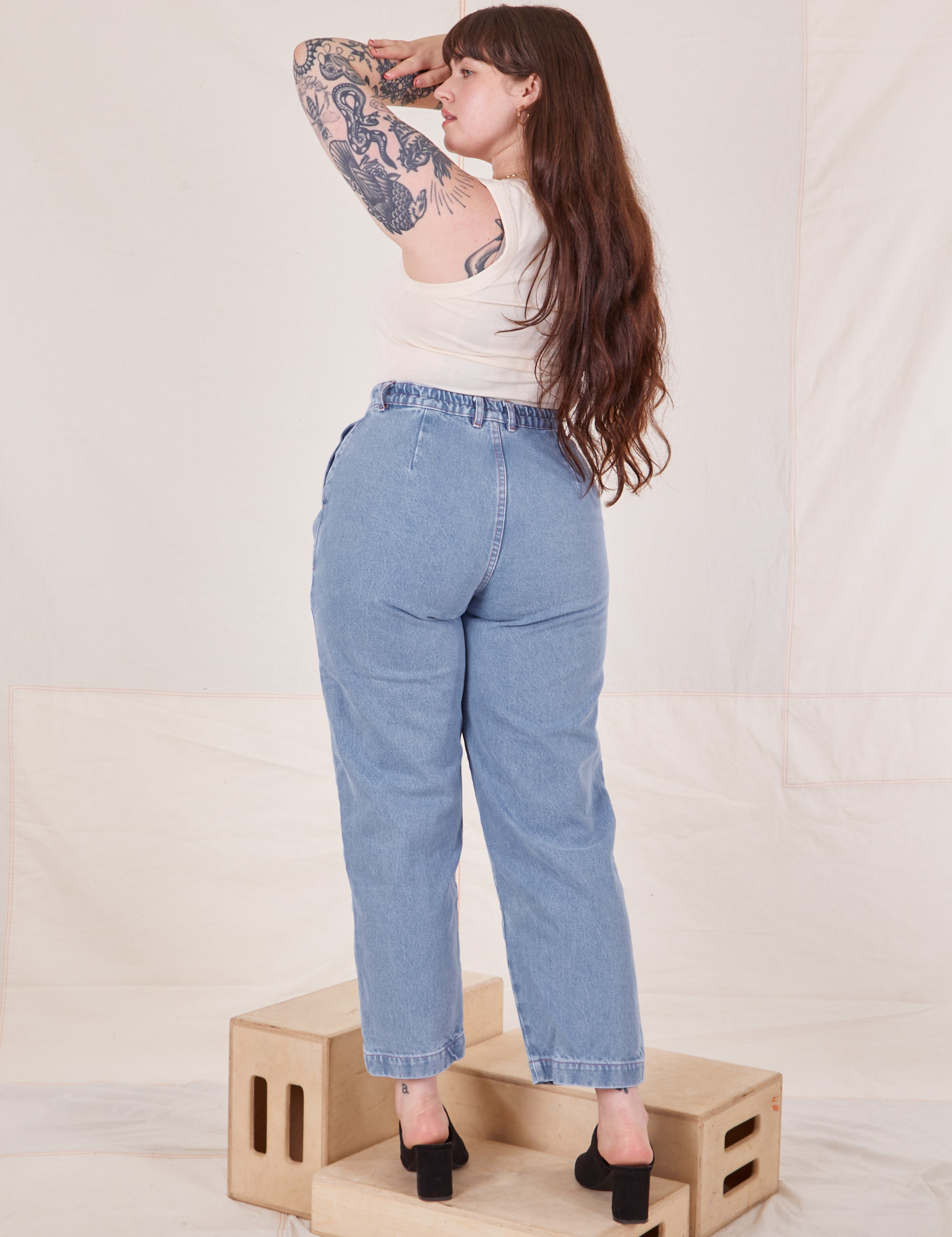 Back view of Denim Trouser Jeans in Light Wash and Tank Top in vintage tee off-white on Sydney