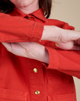 Sleeve close up of Denim Work Jacket in Mustang Red on Alex