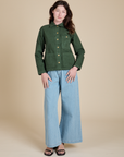 Alex is wearing Denim Work Jacket in Swamp Green and light wash Indigo Wide Leg Trousers