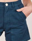 Classic Work Shorts in Lagoon front pocket close up. Madeline has her hand in the pocket.