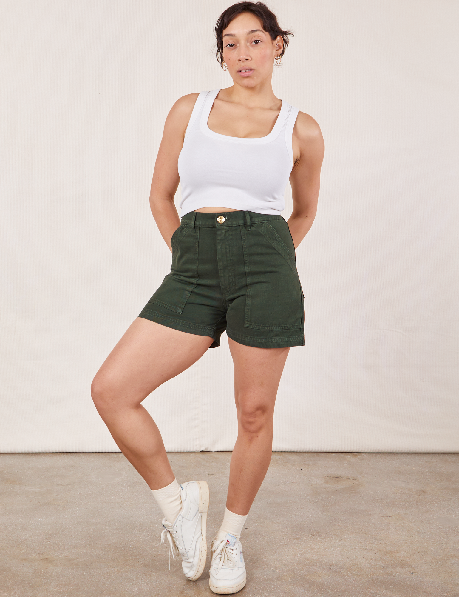Tiara is wearing Classic Work Shorts in Swamp Green and a Cropped Tank Top in vintage tee off-white