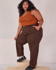 Side view of Overdyed Denim Trouser in Fudge and burnt terracotta Cropped Tank on Morgan