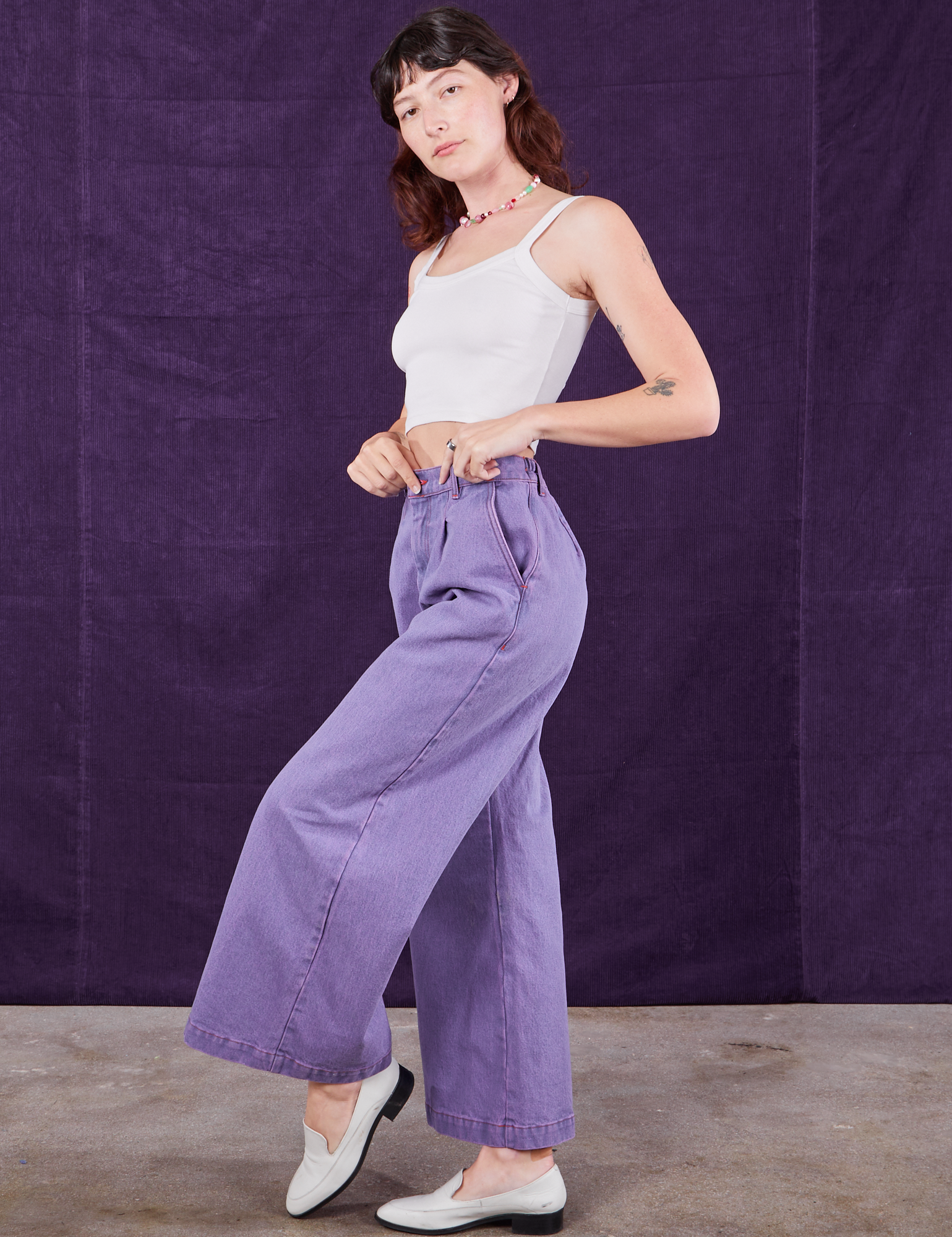 Side view of Overdyed Wide Leg Trousers in Faded Grape and Cropped Cami in vintage tee off-white on Alex