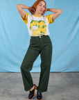 Tiara is wearing Anniversary Tee in Lemon tucked into Swamp Green Work Pants