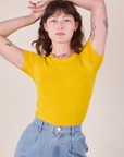 Alex is wearing Baby Tee in Golden Yellow