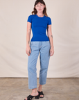 Alex is wearing Baby Tee in Royal Blue and light wash Trouser Jeans