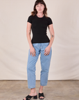Alex is wearing Baby Tee in Vintage Basic Black and light wash Trouser Jeans