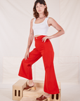 Angled view of Bell Bottoms in Mustang Red and Cropped Tank Top in vintage tee off-white worn by Alex