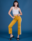 Alex is wearing Painted Work Pants in Mustard Yellow and Cropped Tank in Vintage Tee White