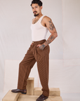 Side view of Checker Trousers in Brown & Black and Tank Top in vintage tee off-white on Jesse