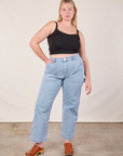 Lish is wearing Cropped Cami in Basic Black and light wash Carpenter Jeans