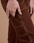 Carpenter Jeans in Fudgesicle Brown pant leg side view close up on Alex