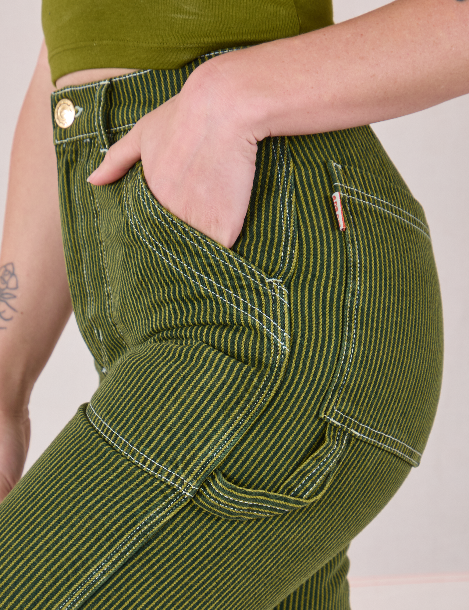 Close up of Alex's hand in the front pocket of Railroad Carpenter Jeans in Summer Olive