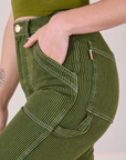 Close up of Alex's hand in the front pocket of Railroad Carpenter Jeans in Summer Olive
