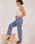 Side view of Carpenter Jeans in Railroad Stripes and Tank Top in vintage te off-white worn by Tiara