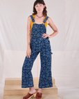 Alex is wearing Carpenter Overalls in Lazy Daisy