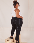 Angled back view of Carpenter Jeans in Black worn by Morgan