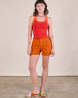 Alex is wearing Colorblock Cropped Tank in Mustang Red and burnt orange Work Shorts